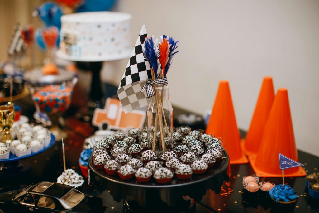 A table with cupcakes, candy and cones