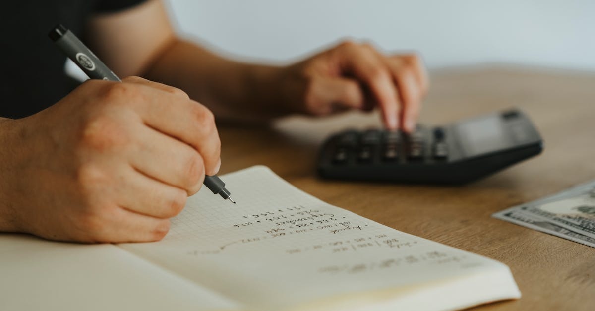 Photo of a person doing accounting, showing tracked business expenses.